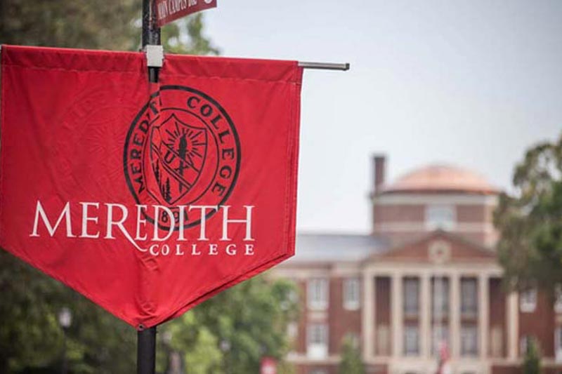 Meredith Banner with Johnson Hall in background